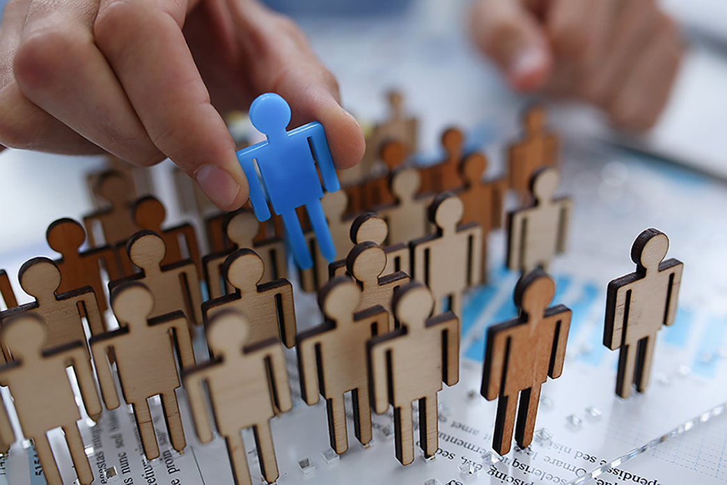 hand holding blue individual figure