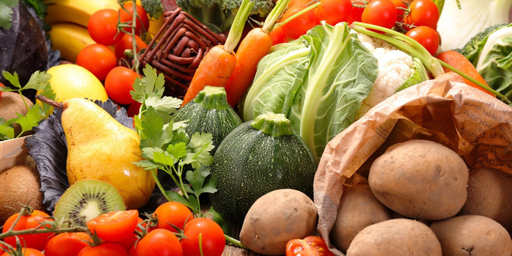 A colorful assortment of various fruits and vegetables arranged together on a surface.