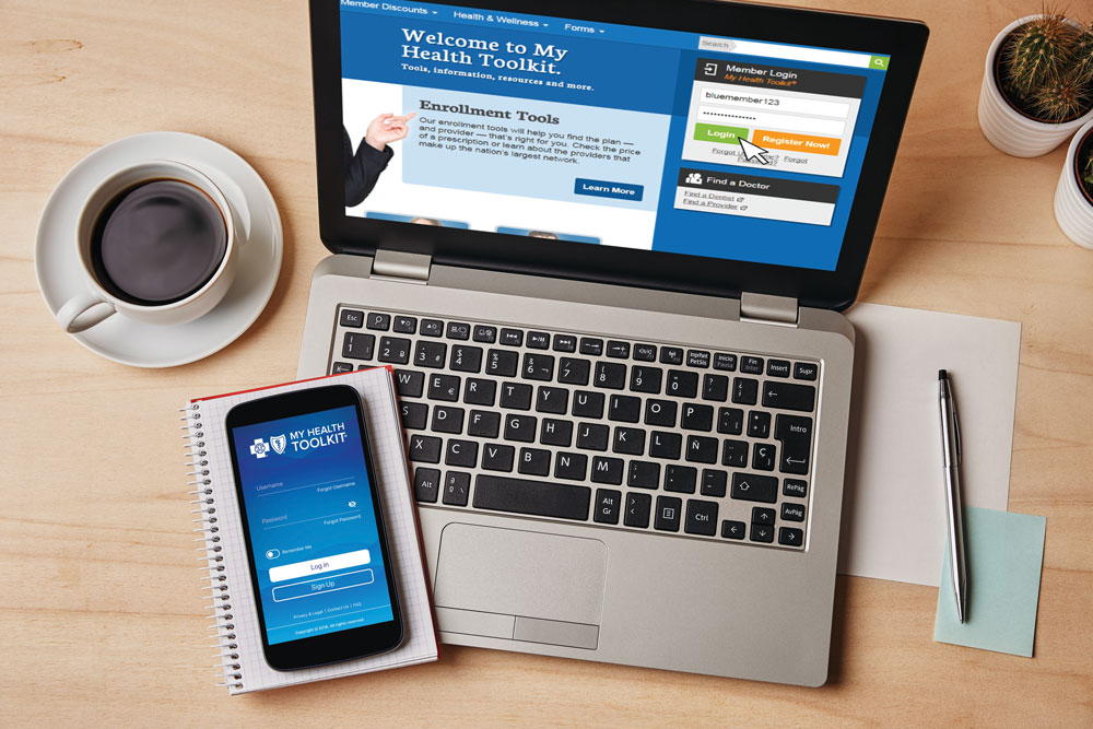 laptop and mobile phone on table open to my health toolkit app